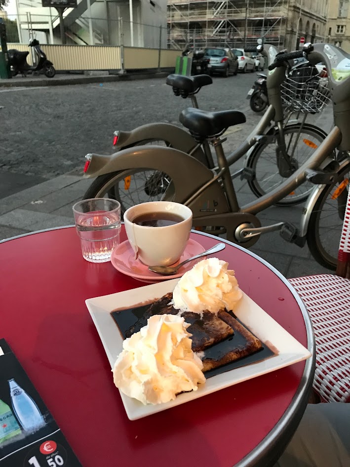 Chocolate crêpes and our bicycles at a Paris café